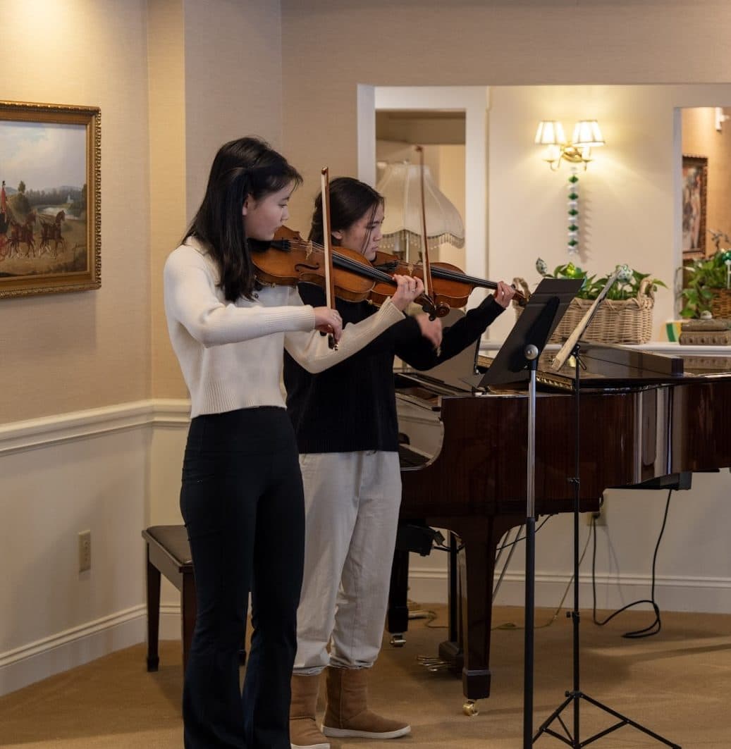 Residents seated together for a live student performance