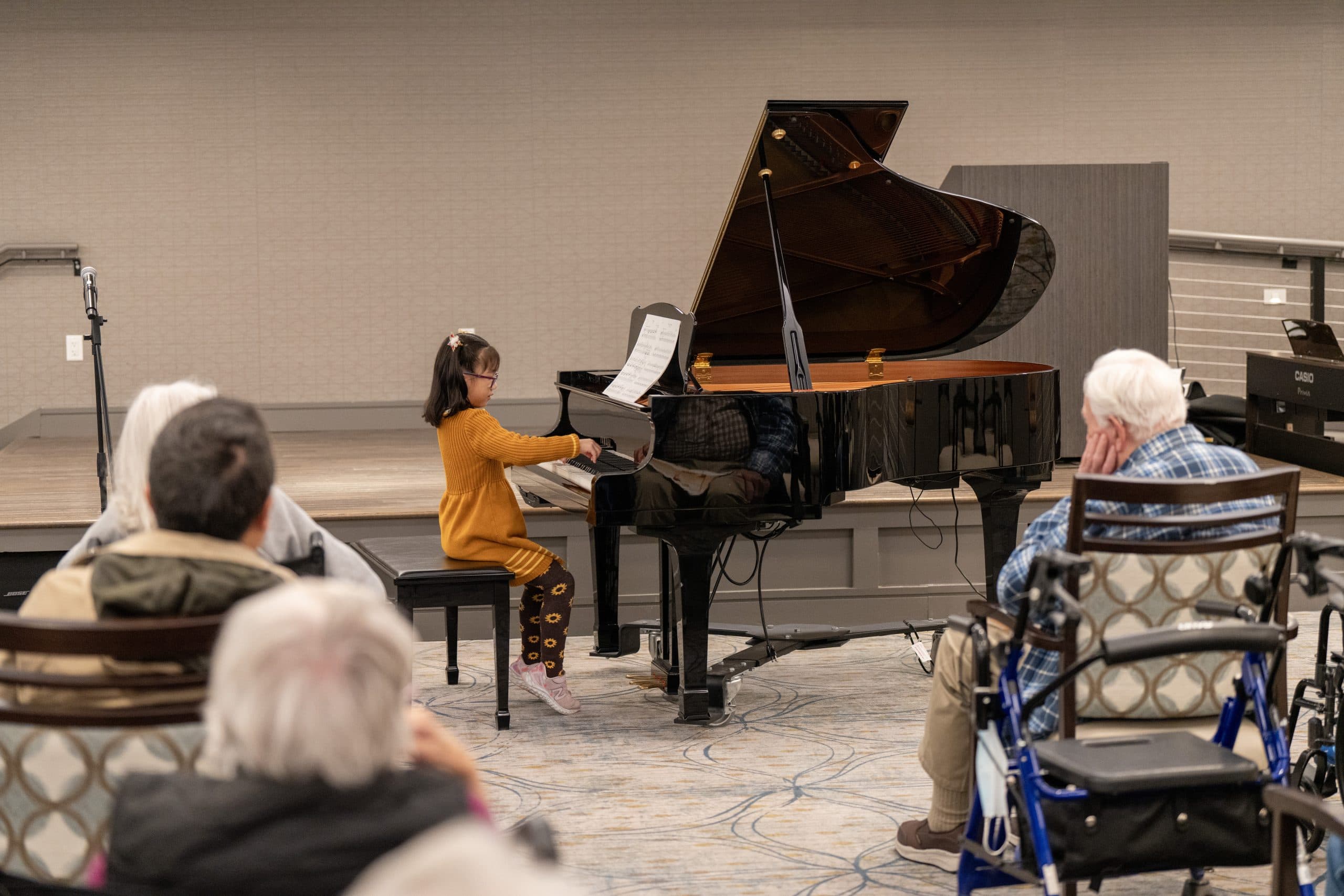 Young musicians perform together for residents