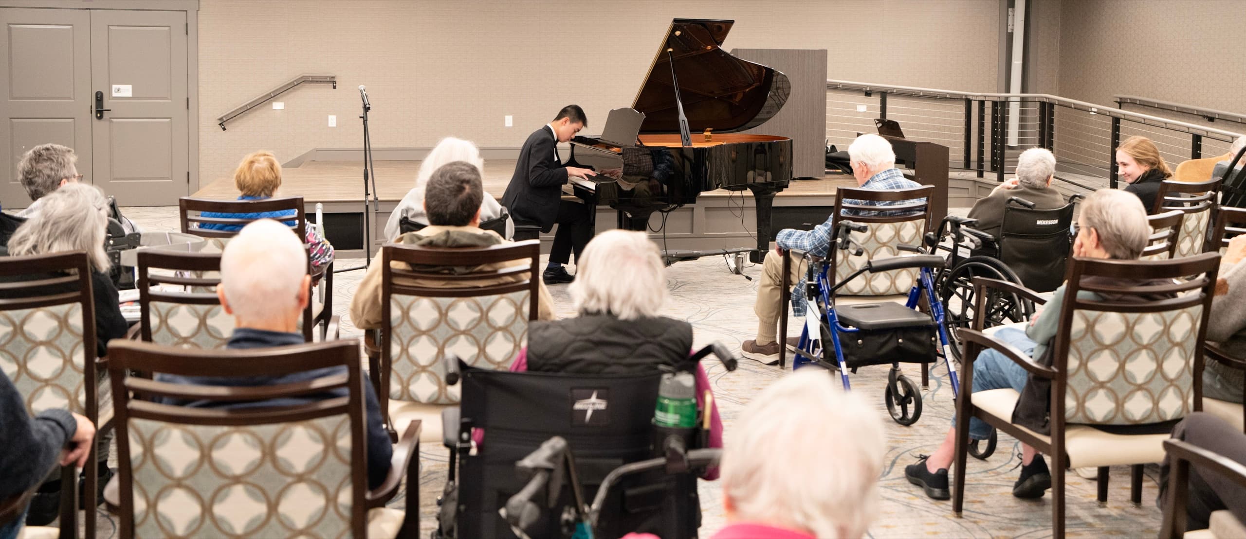 A young pianist performs for residents