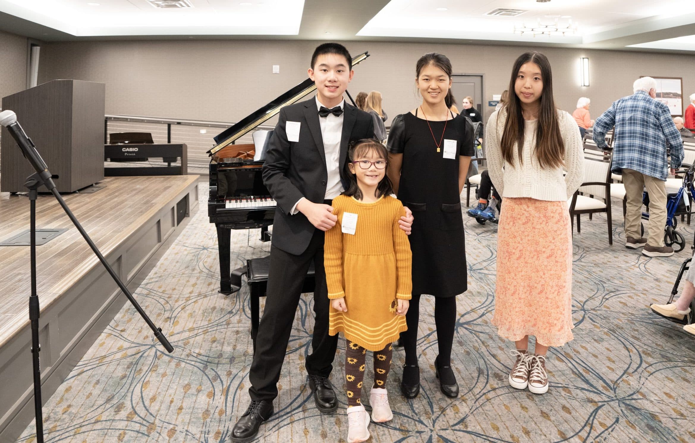 A young musician performs for residents in a senior community